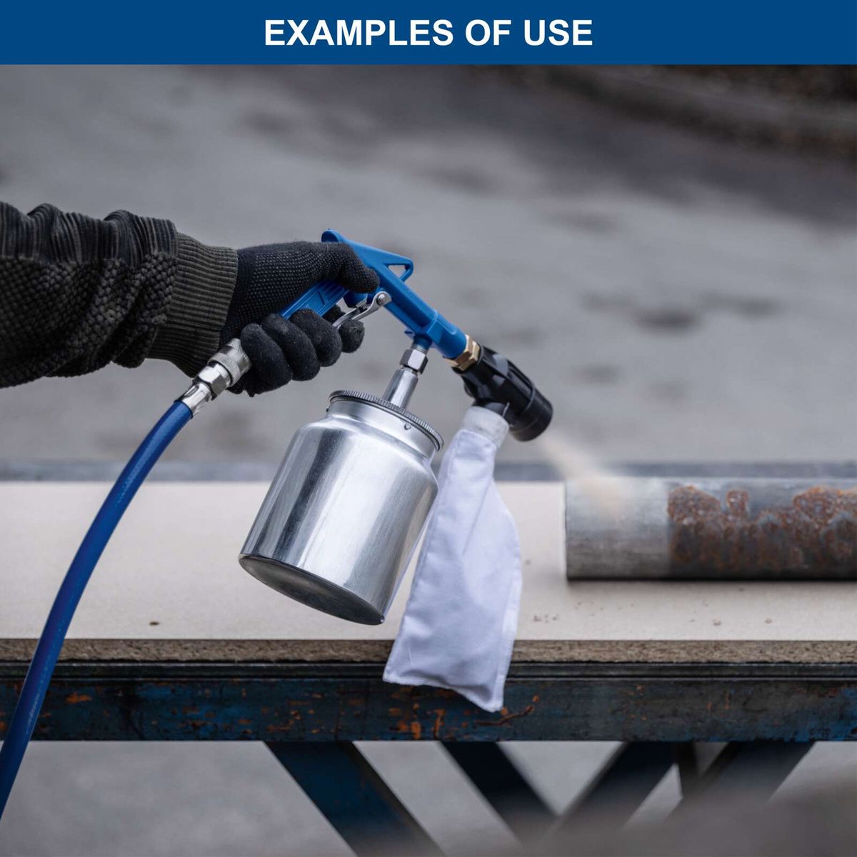 Gloves protecting hands while operating a spray gun with attached container