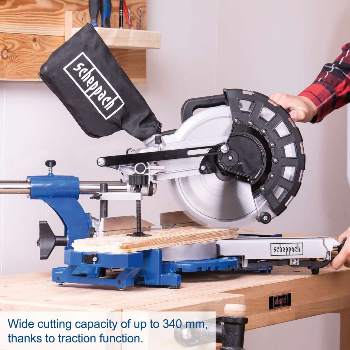 Scheppach sliding mitre saw showing 340 mm cutting capacity with traction feature, cutting board and handle