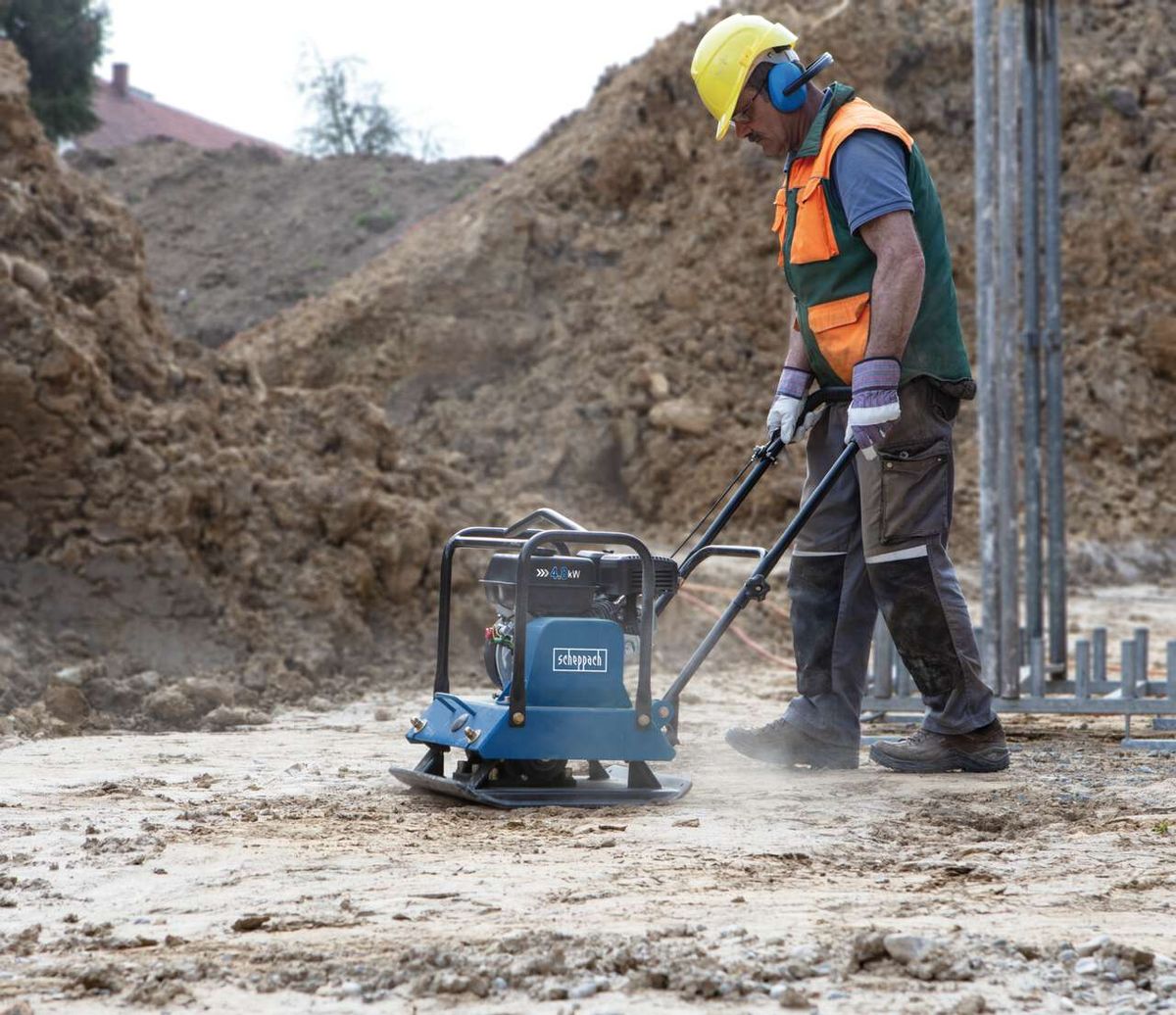 Scheppach compact plate compactor in use with base plate and wheels on site