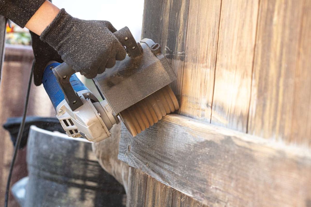 Scheppach abrasive strap brush in use on wooden material