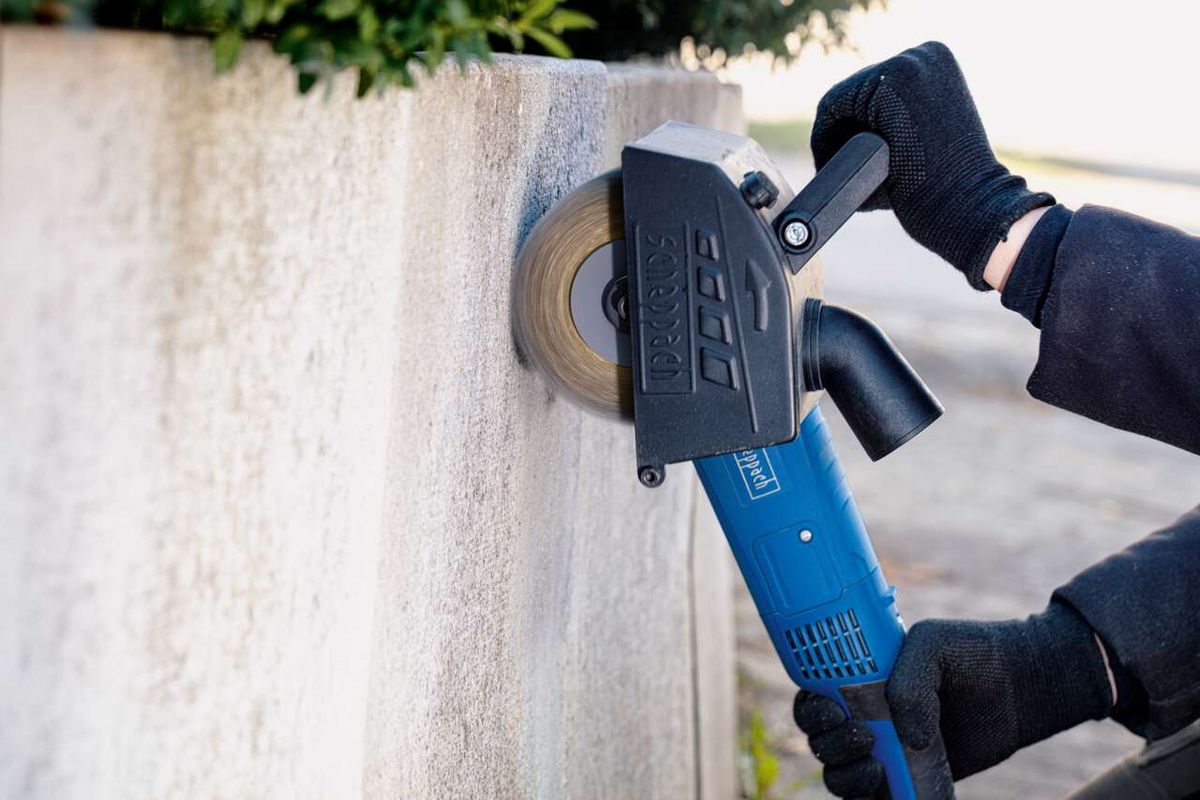 Scheppach brass wire brush with handheld grinding tool in use on surface