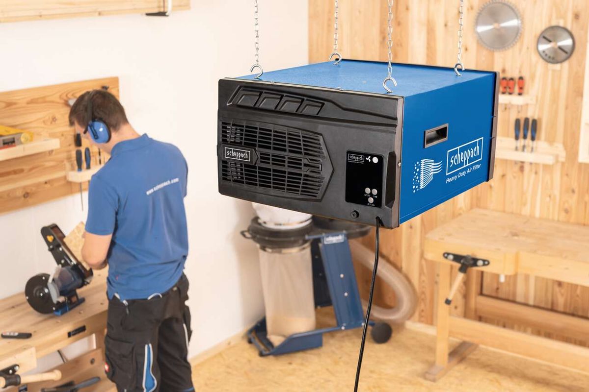 Scheppach HDA-14 air purifier with remote control, suspended in workshop setting
