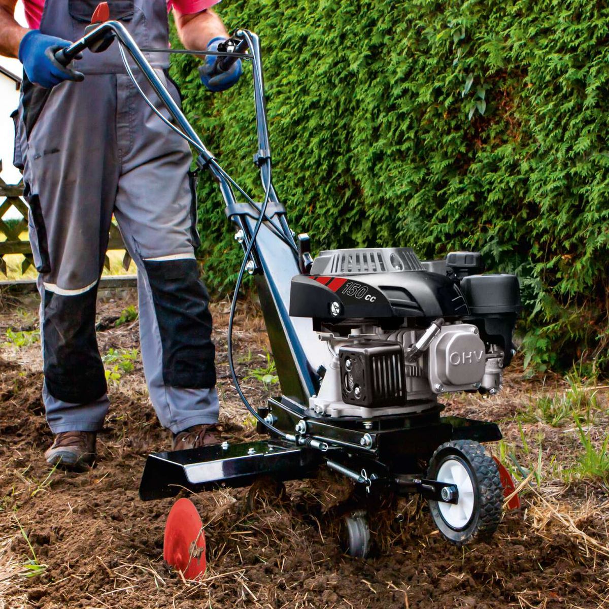 Scheppach motorized backhoe with engine and attachment, shown in use on ground