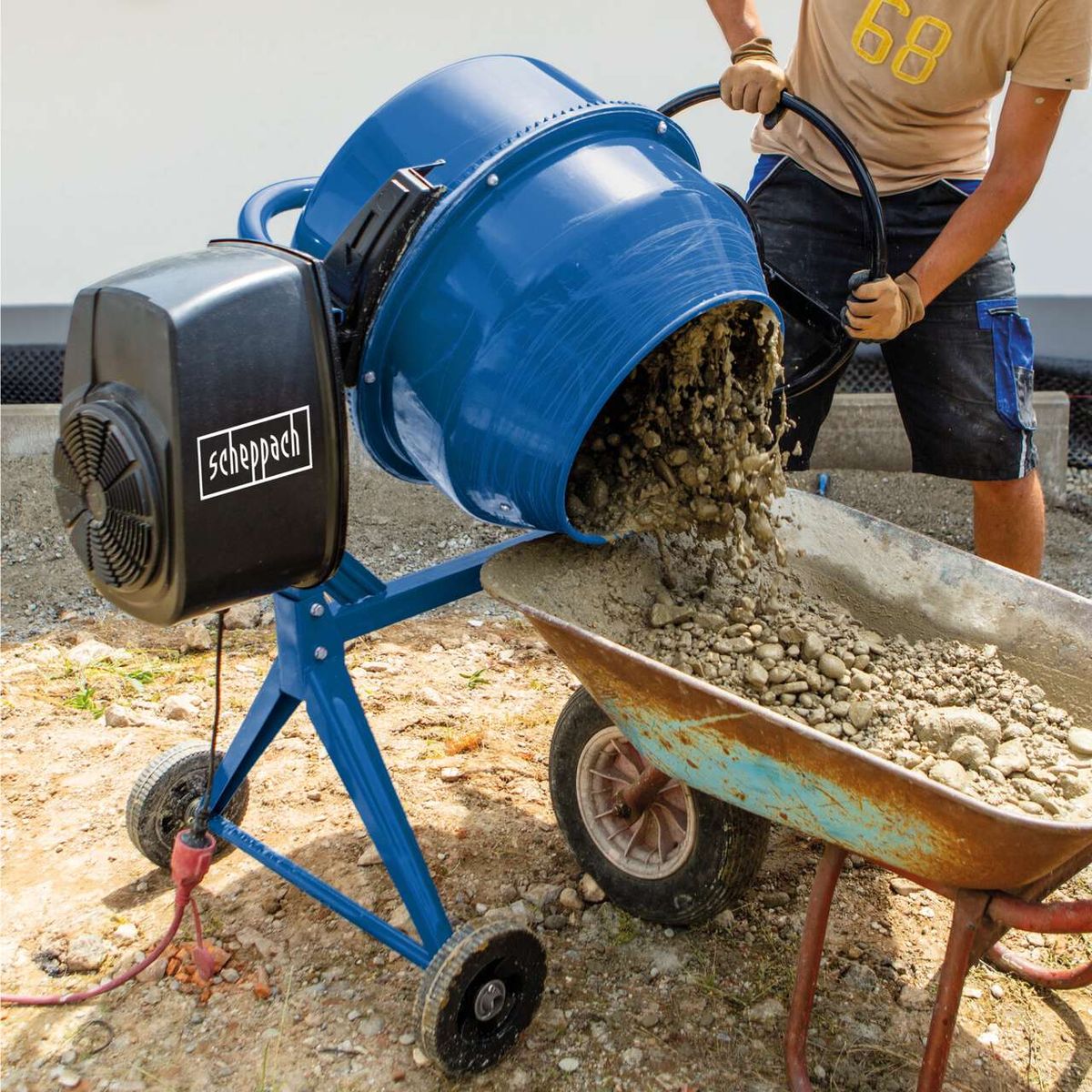 Scheppach 125L cement mixer with gear-driven mixing drum, operating in use