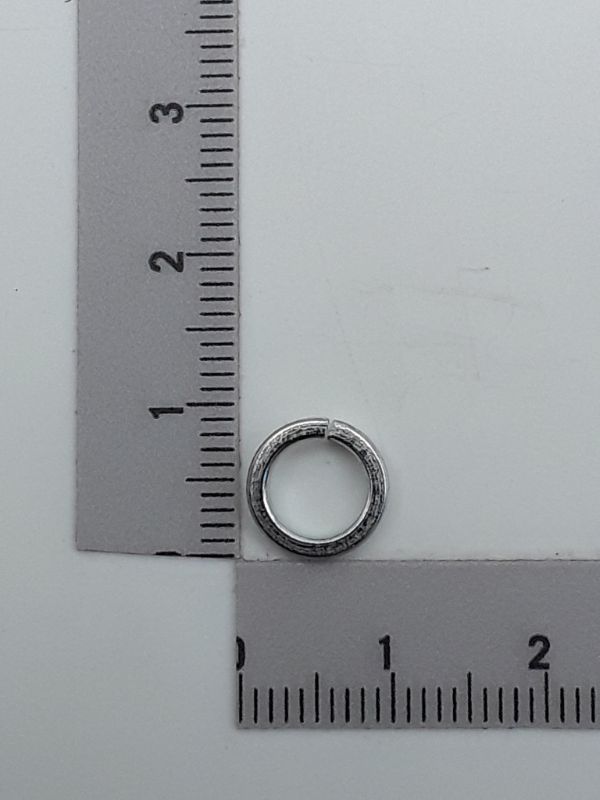 Spring washer by Scheppach, side view, next to a ruler for size reference.