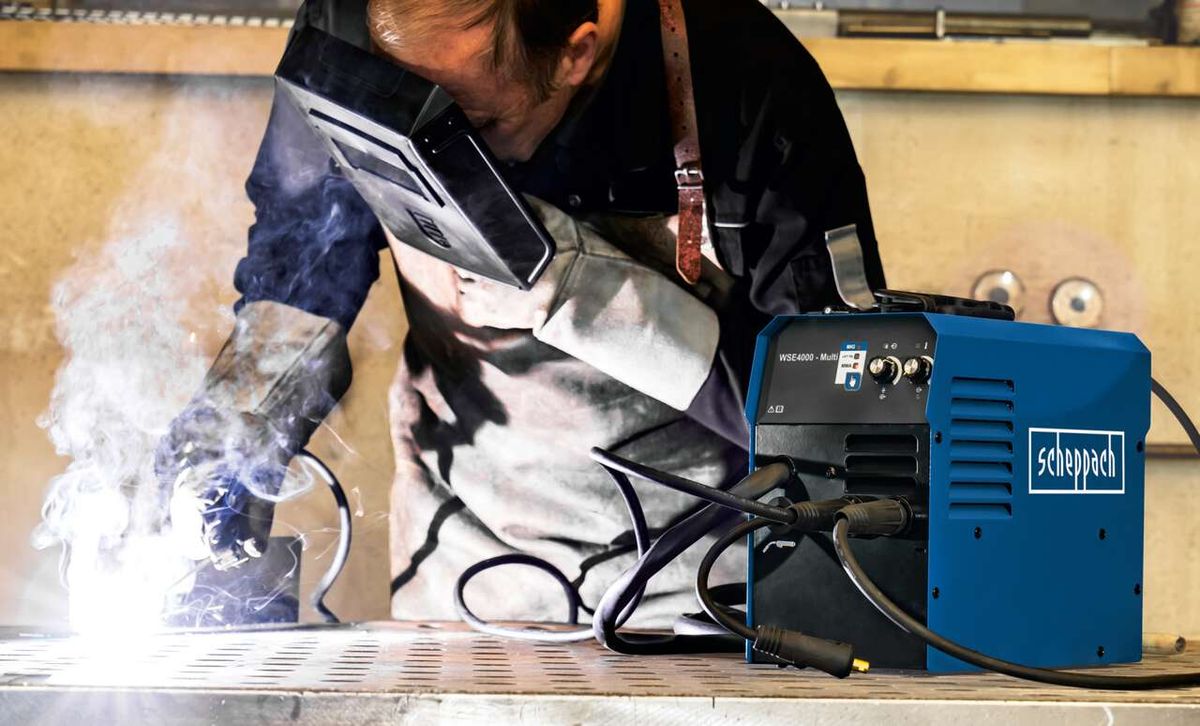 Welder operating Scheppach WSE4000 multi-purpose welding machine during a welding process