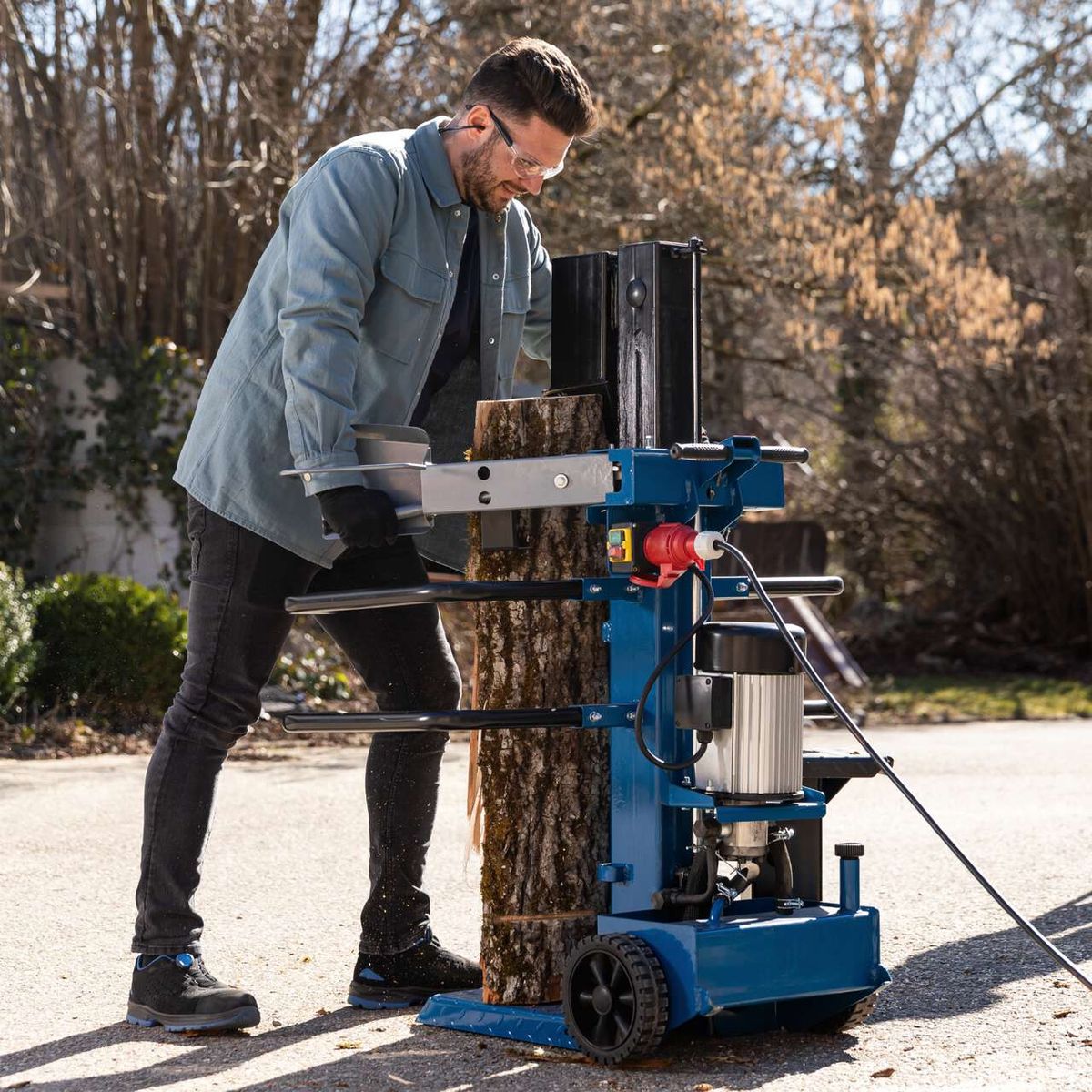 Compact 8T vertical log splitter with workbench and control glove shown in use