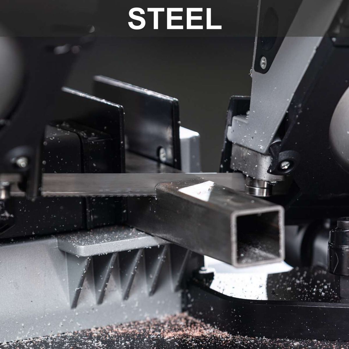 Metal band saw with worktable and LED lighting, showing cutting mechanism detail