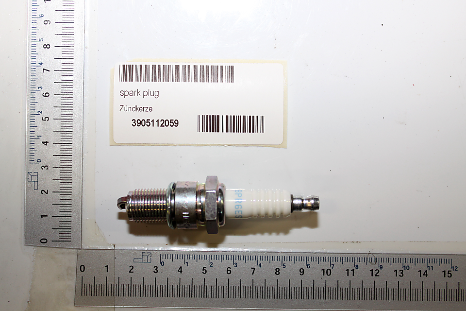 Scheppach spark plug with serial number, measured against scale