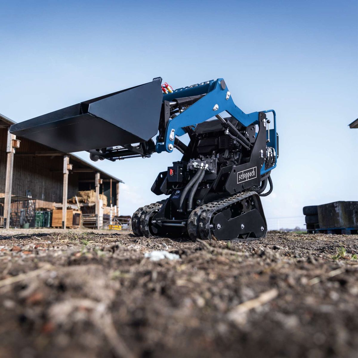 Scheppach compact loader with attachment set including ball spike and grab bucket