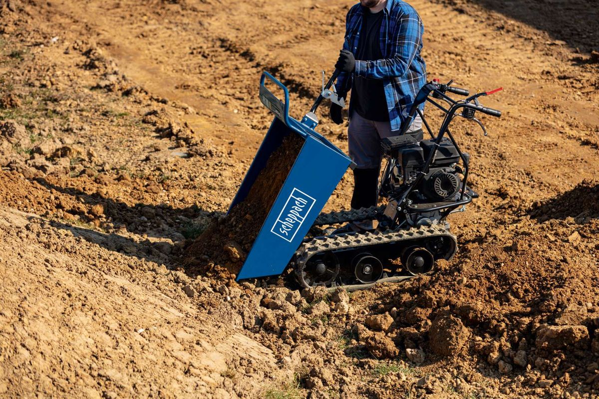Scheppach dumper with bucket for transporting soil, operating on open terrain