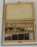 Wooden case containing a 103-piece tool set for a jigsaw with various brushes and attachments