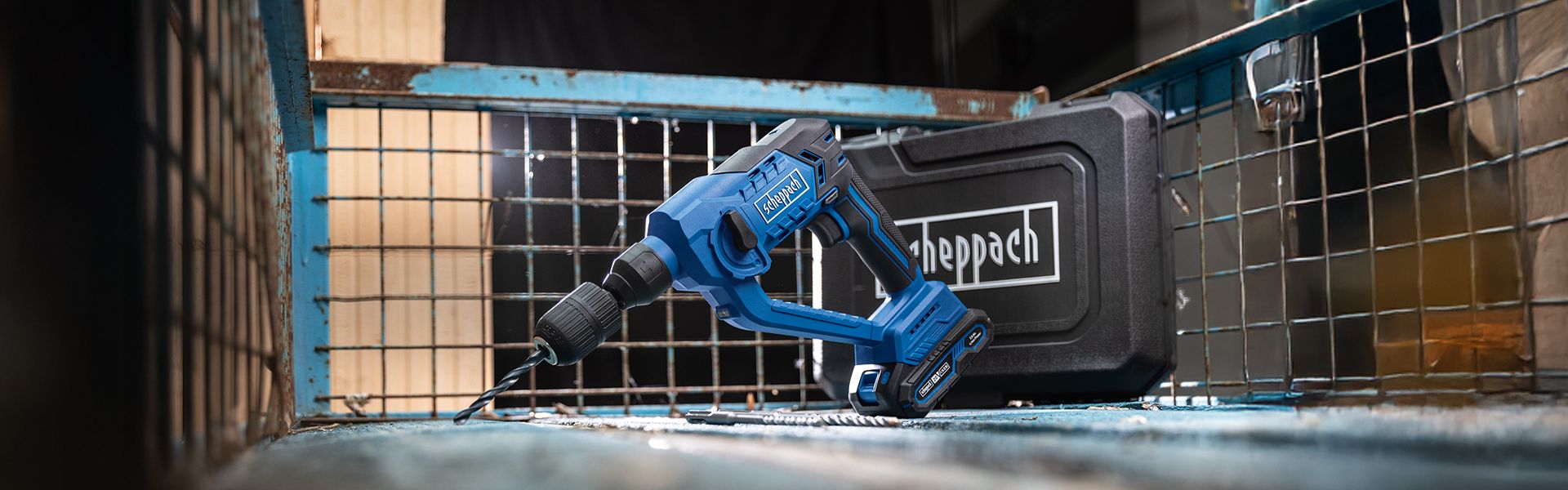 A Scheppach cordless drill in a tool case. The drill is blue and white.